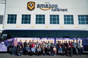 MSCTL students pose in front of a UW bus during a tour of an Amazon Fulfillment Center.